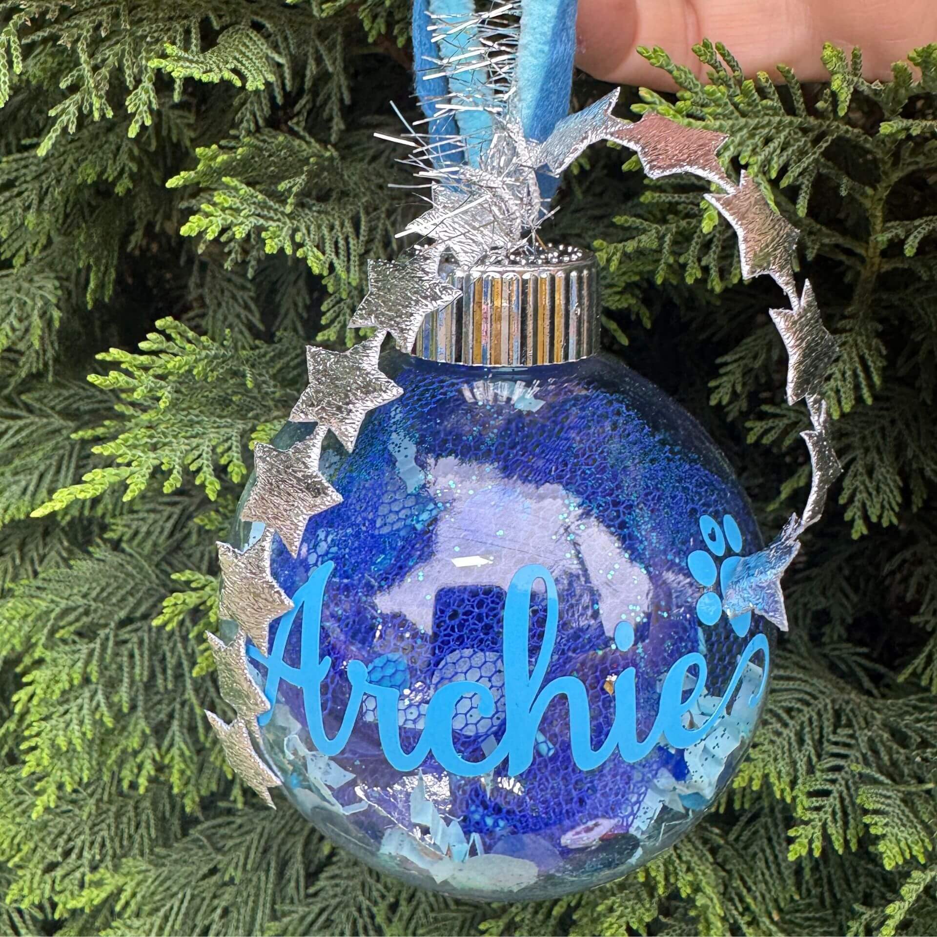 Decorative ornament with 'Archie' on a tree