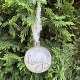 Decorative ornament with 'Lucy' engraved on a Christmas tree