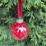 Red Christmas ornament with 'Allee' on a tree